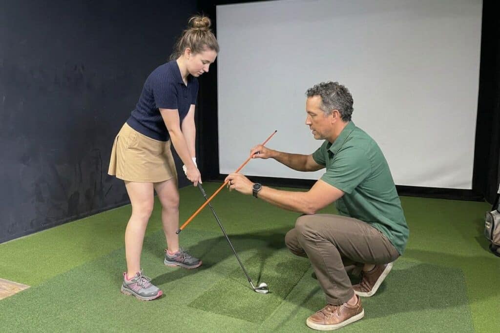 Golf Instructor Teaching a Student in an Indoor Golf Simulator